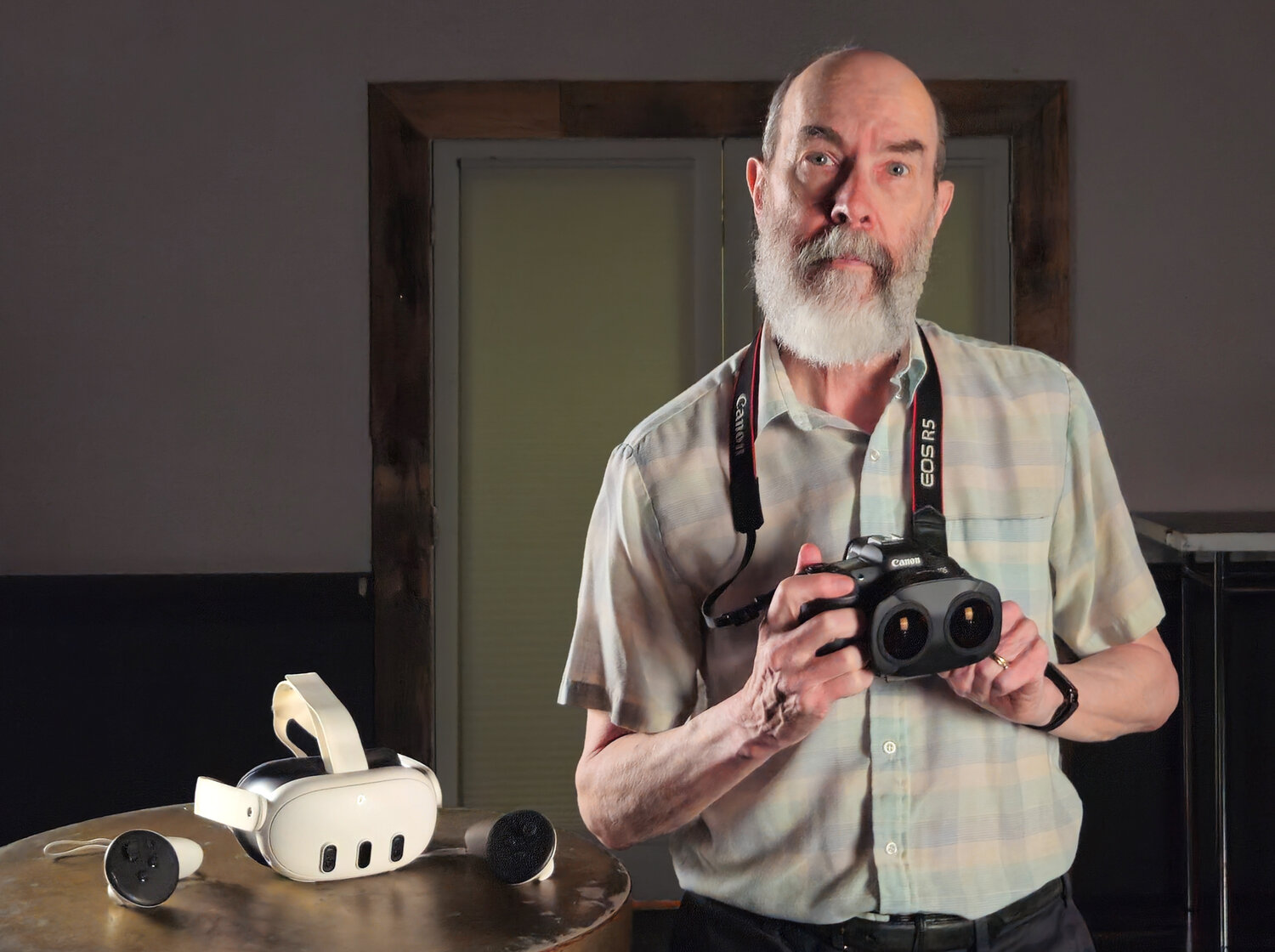 Donald McKillican holding his VR180 camera with VR headset nearby